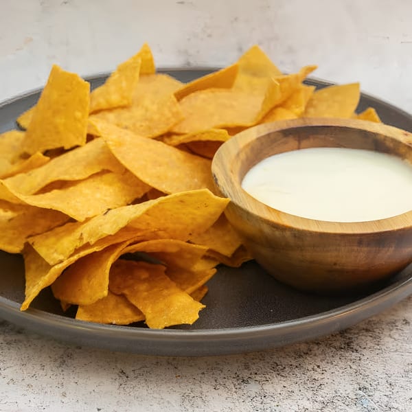 El Que Pasa's crispy tortilla chips served with a side of creamy white queso dip.