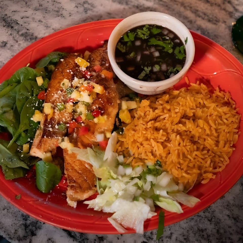 El Que Pasa's Mexican dish with fish, rice, spinach, and a side of black bean soup.